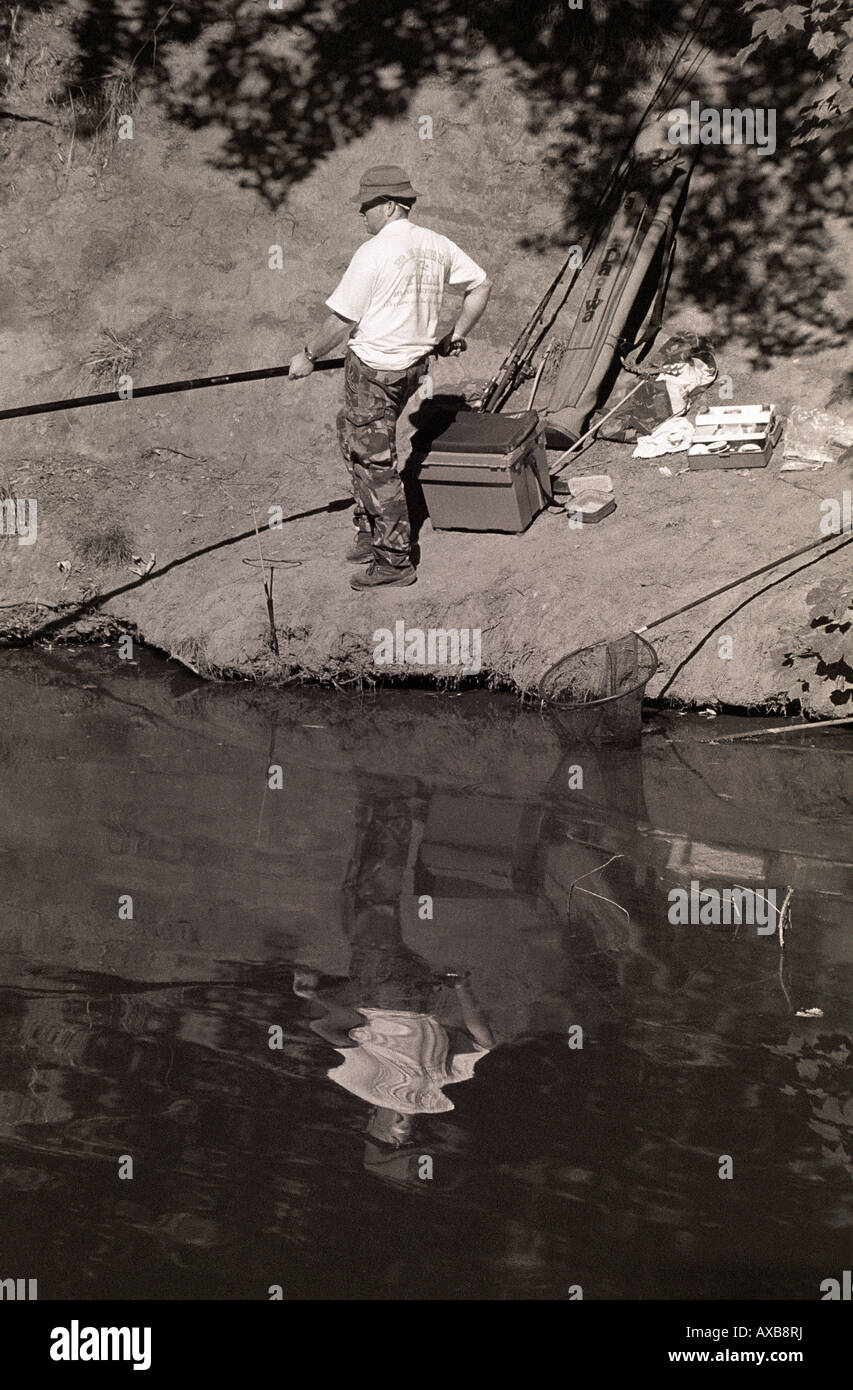 Man fishing on the banks of Lymm Dam, Cheshire, UK Stock Photo Alamy