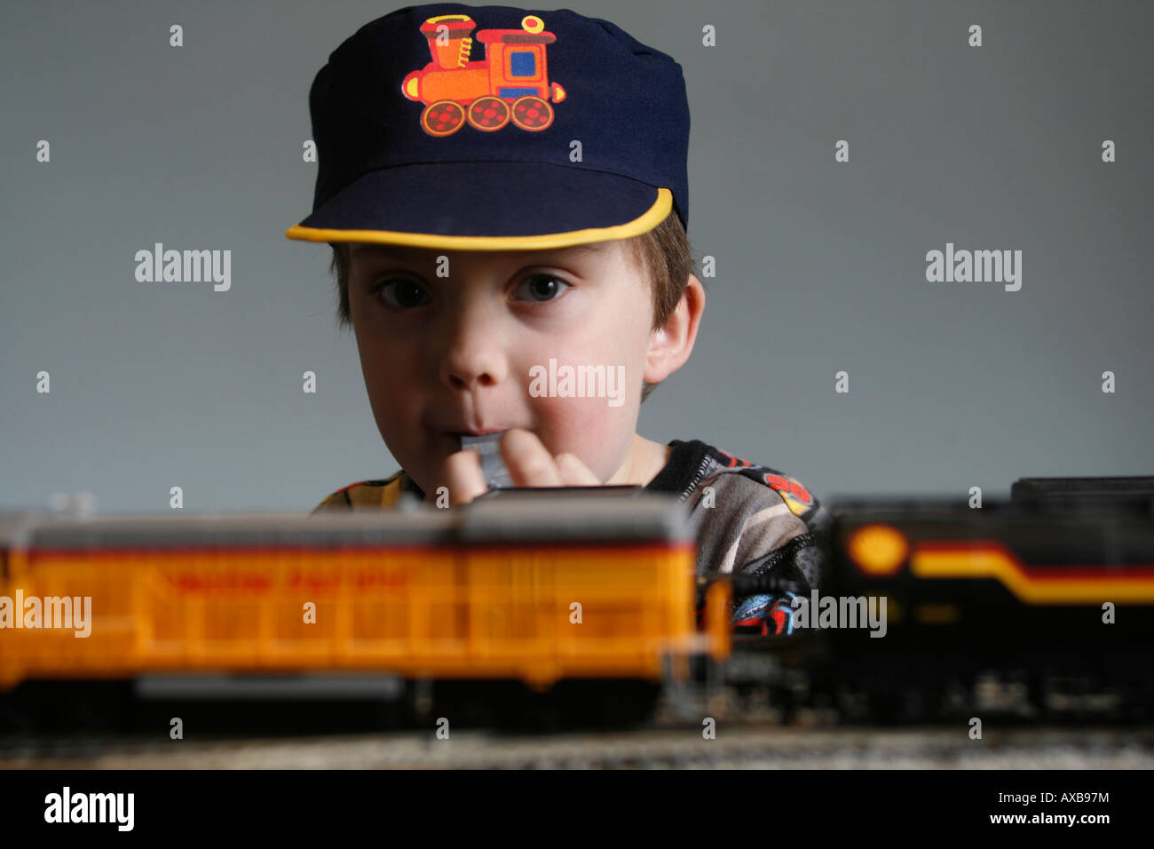 Lewis aged six and his Hornby electric trainset. 00 H0 rolling stock track, Union Pacific train 824, Model train set with track, hat and whistle form part of the game Stock Photo