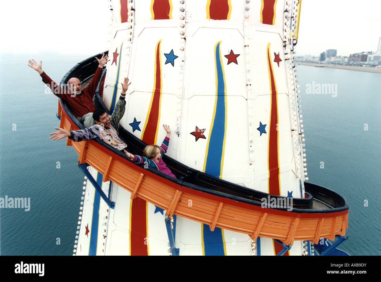Helter skelter on Brighton Palace Pier with the painter Philip Dunn Sgt Stone and a little girl Stock Photo
