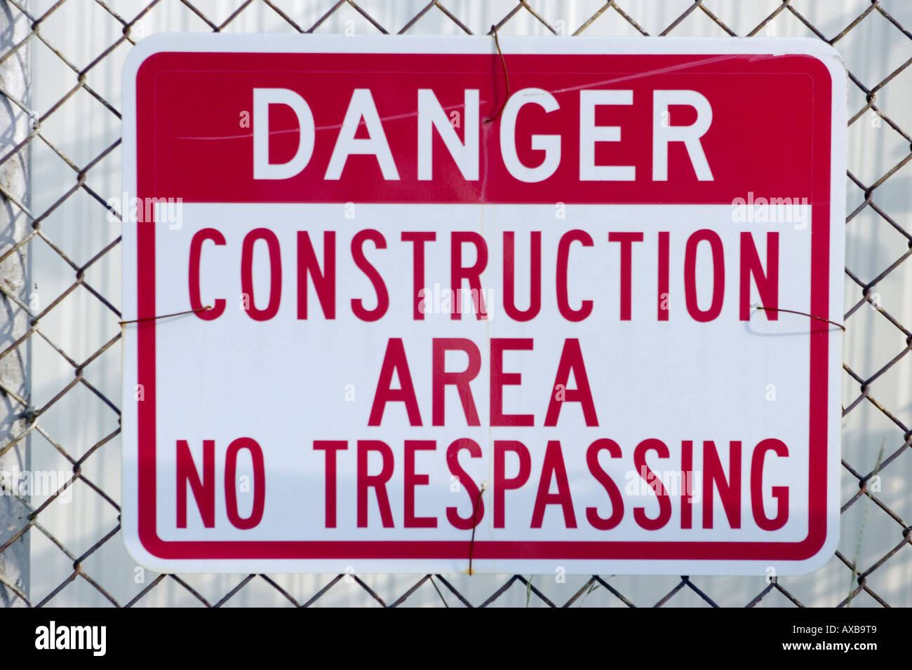 danger construction area no trespassing sign posted on a fence Stock ...