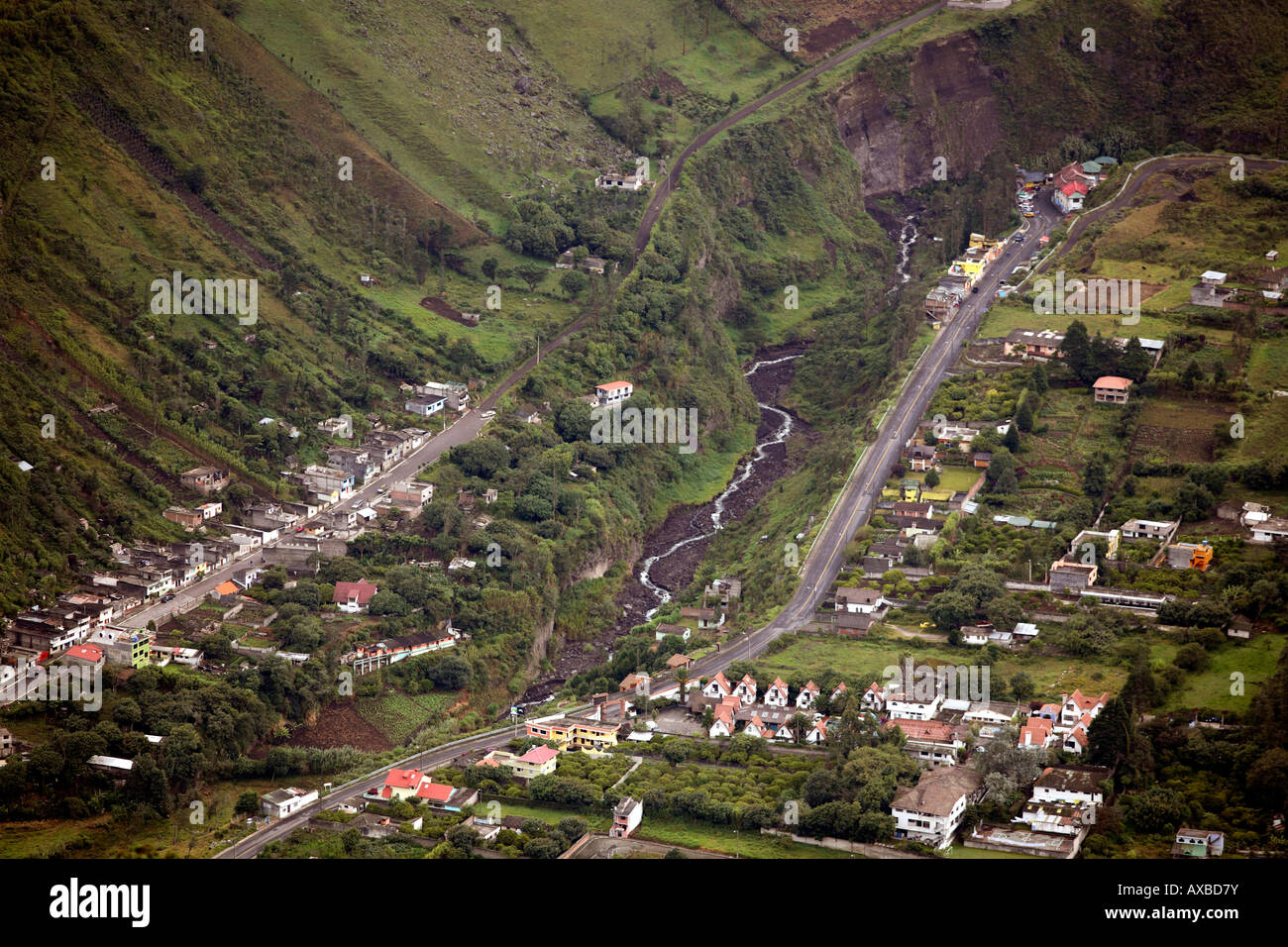 Houses built along the edge of a ravine on the slopes of Tunguragua Volcano in Banos, Ecuador, in a maximum risk zone Stock Photo