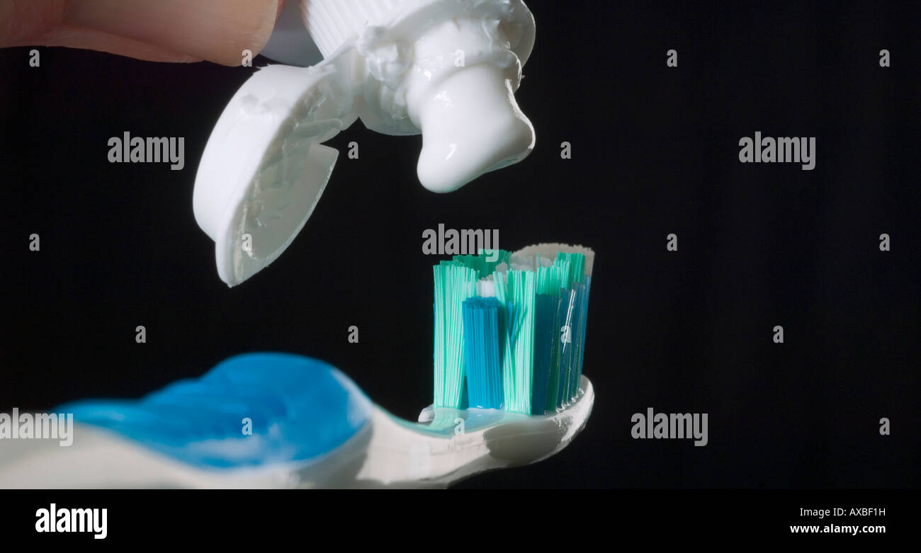 Toothpaste Being Squeezed From A Messy Tube Onto A Toothbrush Stock Photo Alamy