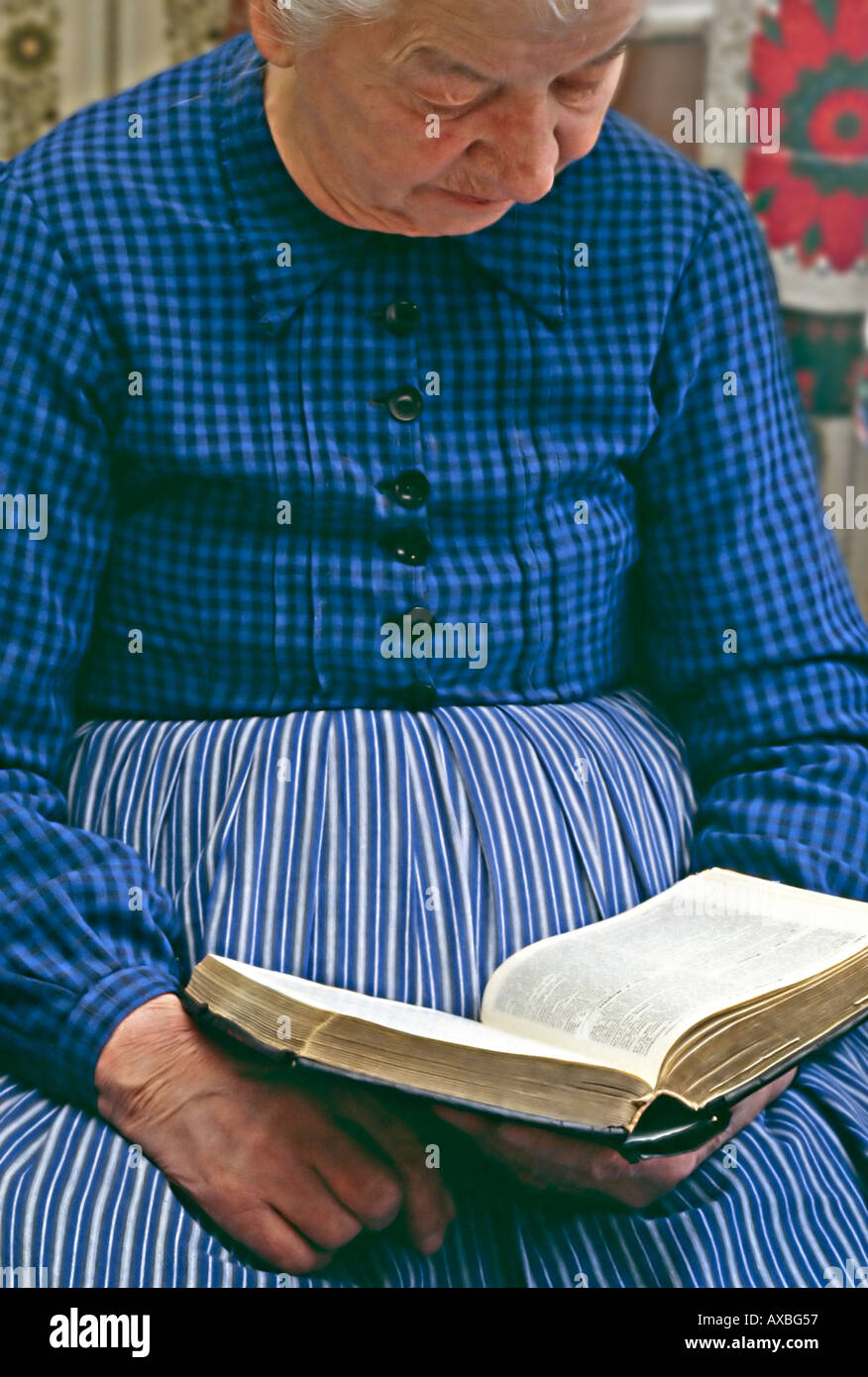 old woman with typical clothes of the region Hesse Germany reading a book the bible Stock Photo