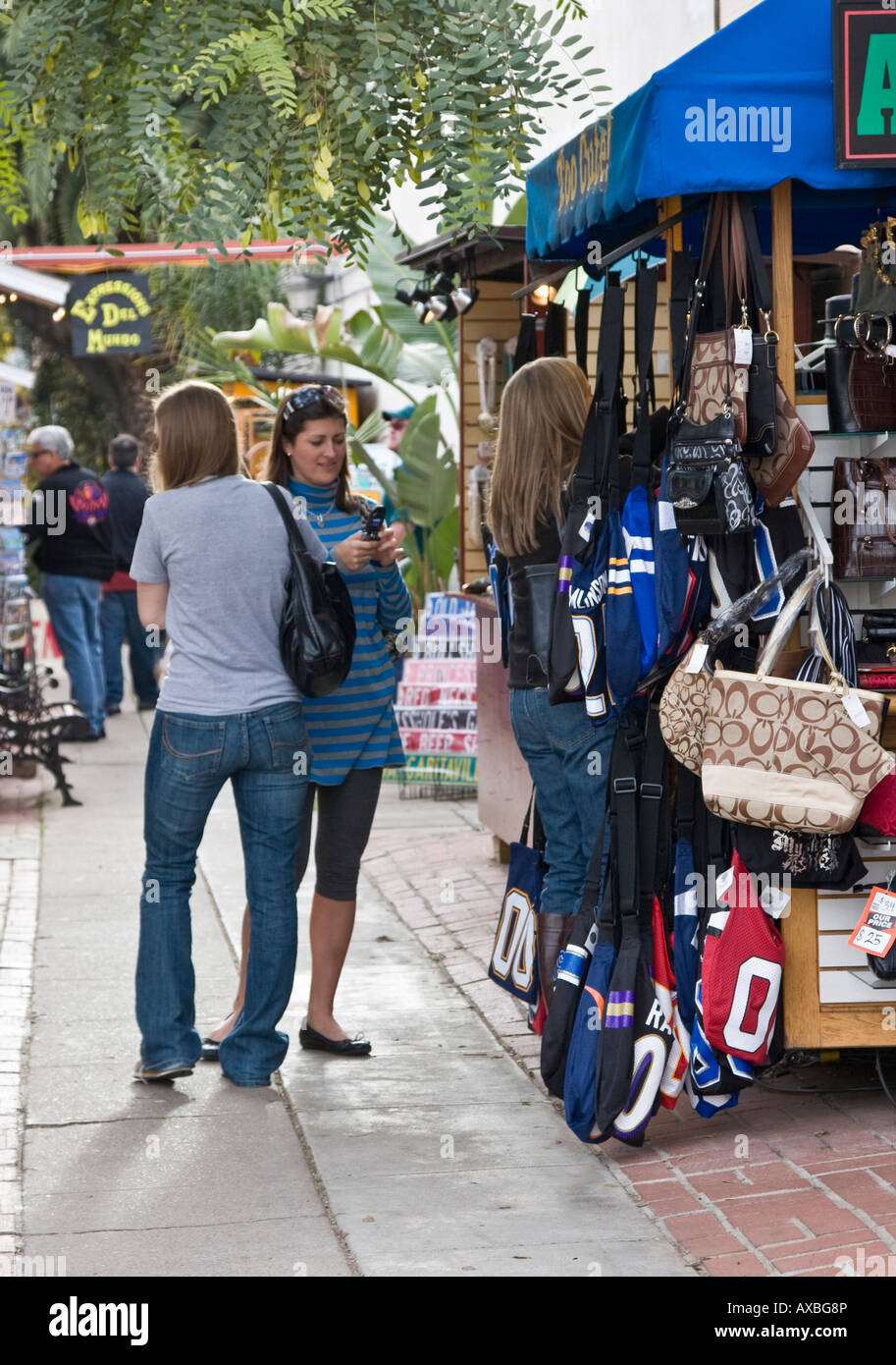 Three female tourists buying gifts from street vendor in San Diego Old Town Stock Photo
