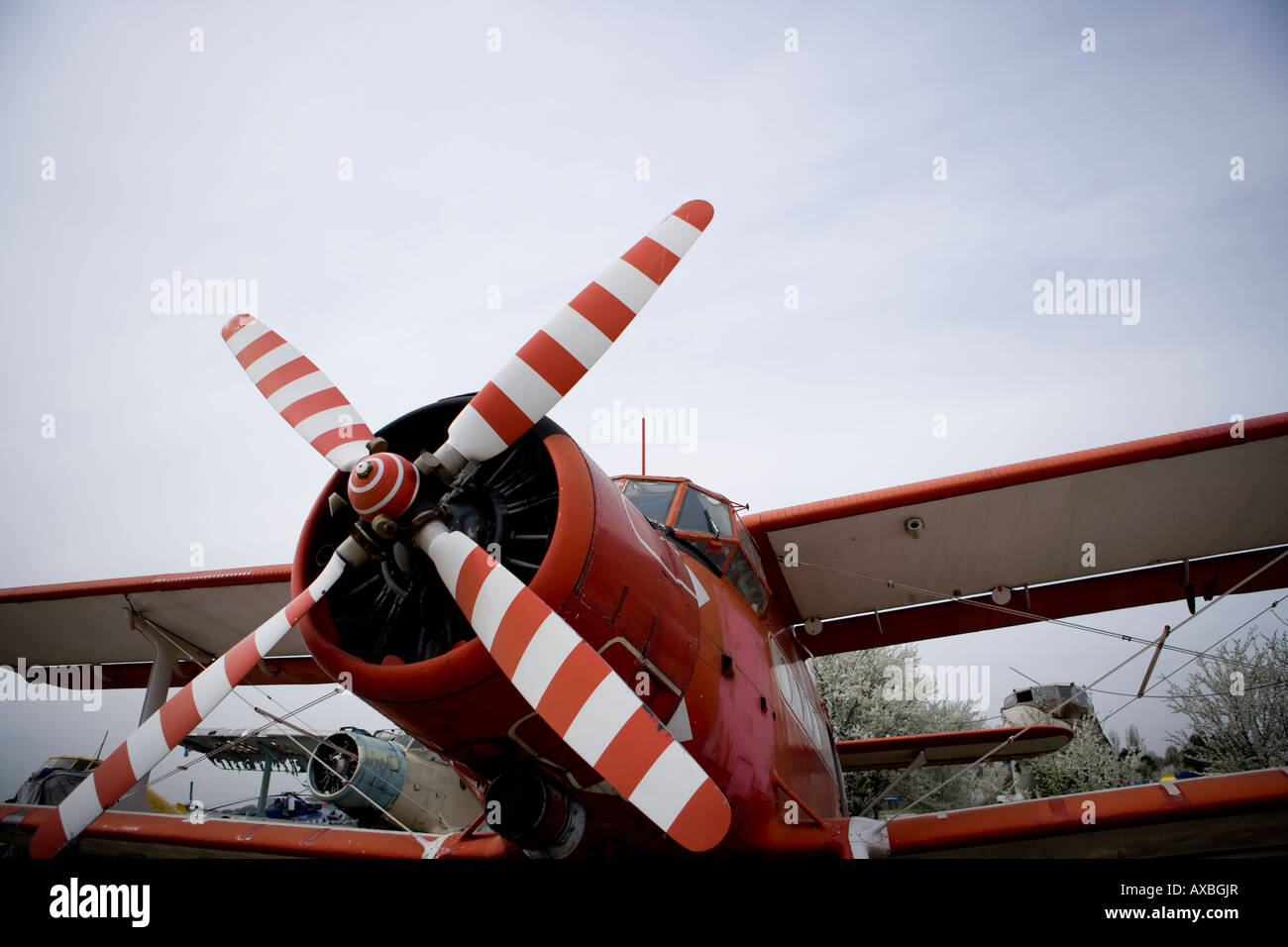 biplane airplane landed with its propeller raised above Stock Photo
