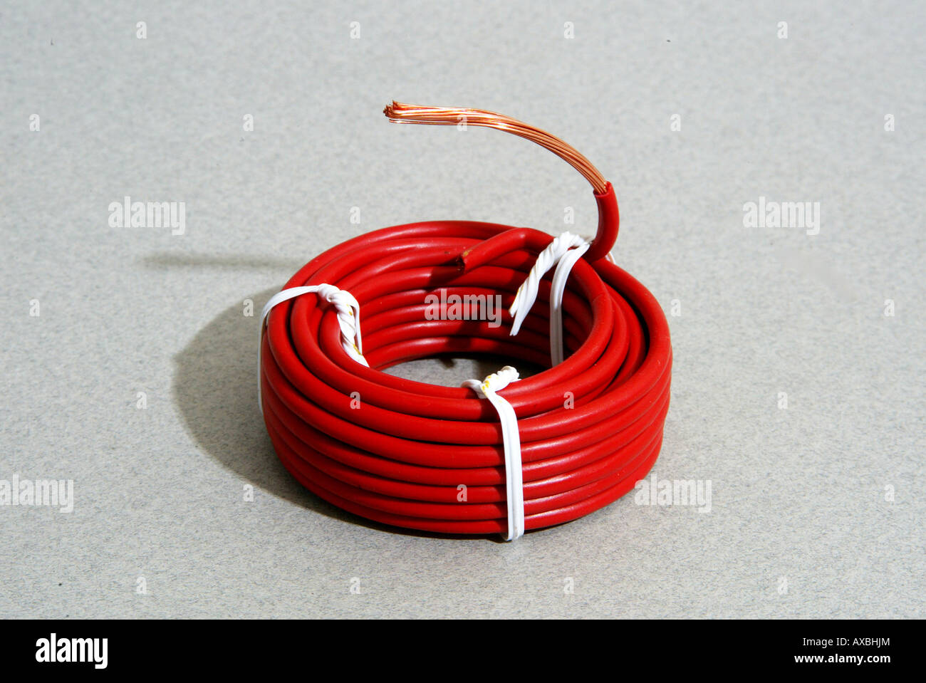 Coil of single conductor wire with red insulation Stock Photo Alamy