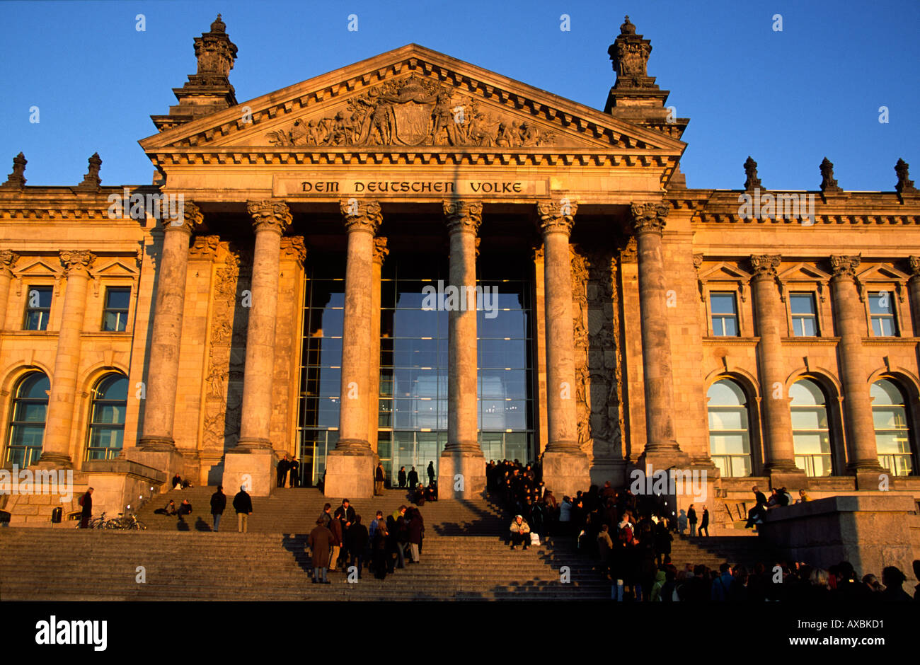 Berlin Reichstag dome by Norman Forster sunset people queeing in front Stock Photo