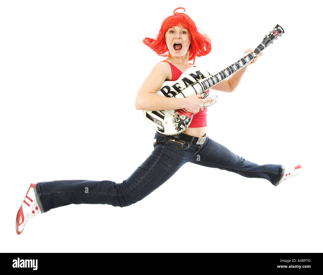 young woman with a red wig playing air guitar Stock Photo