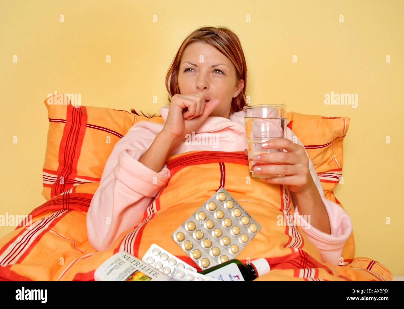 sick woman with medicament lying in bed Stock Photo Alamy