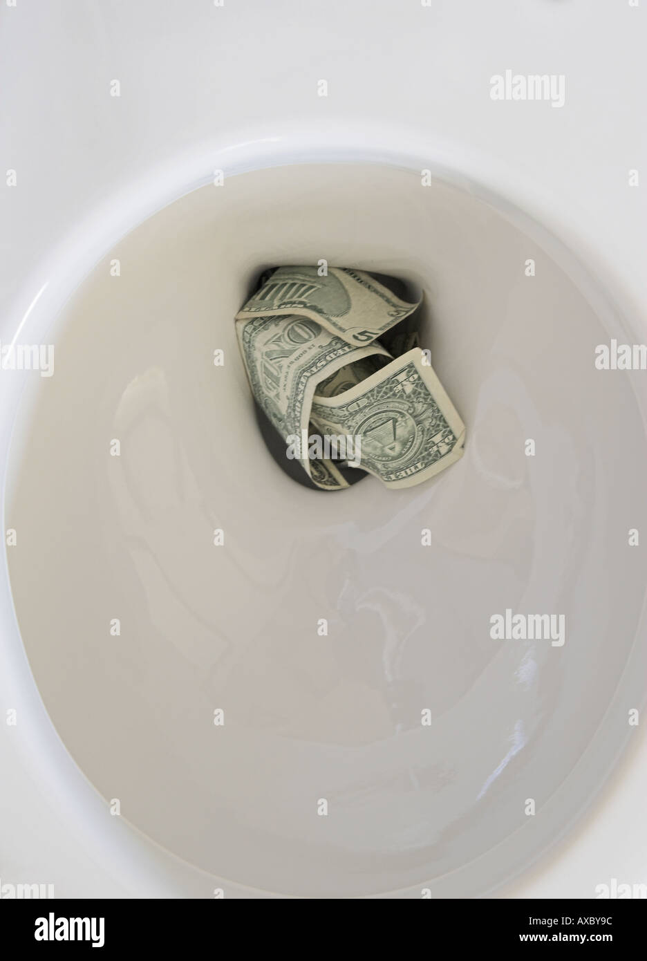 Flushing money down the toilet Stock Photo Alamy