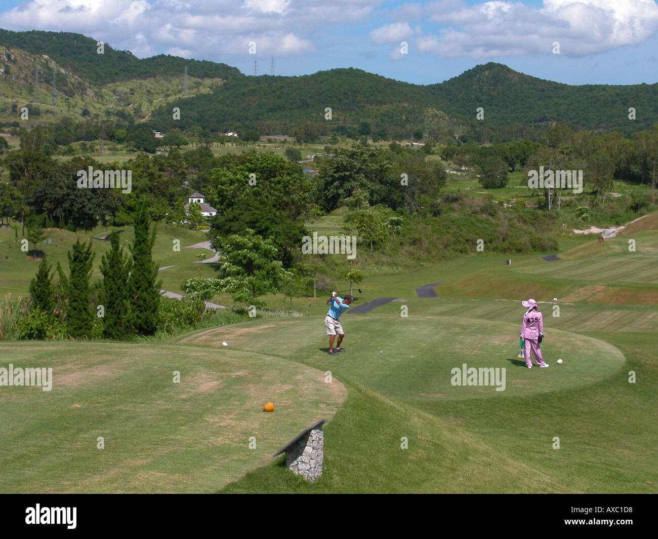 Golfer works straight left arm at the top of the back swing at St Andrews 2000 Golf Club nr Rayong Thailand Stock Photo