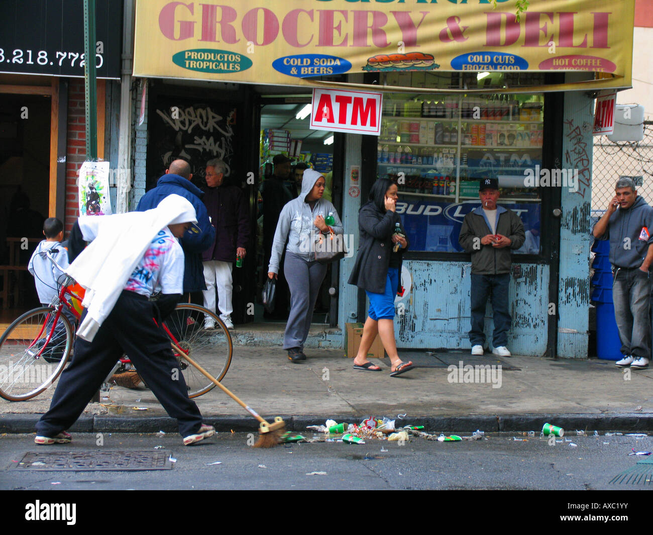 Street cleaner in front of a grocery and deli, USA, Brooklyn, New York