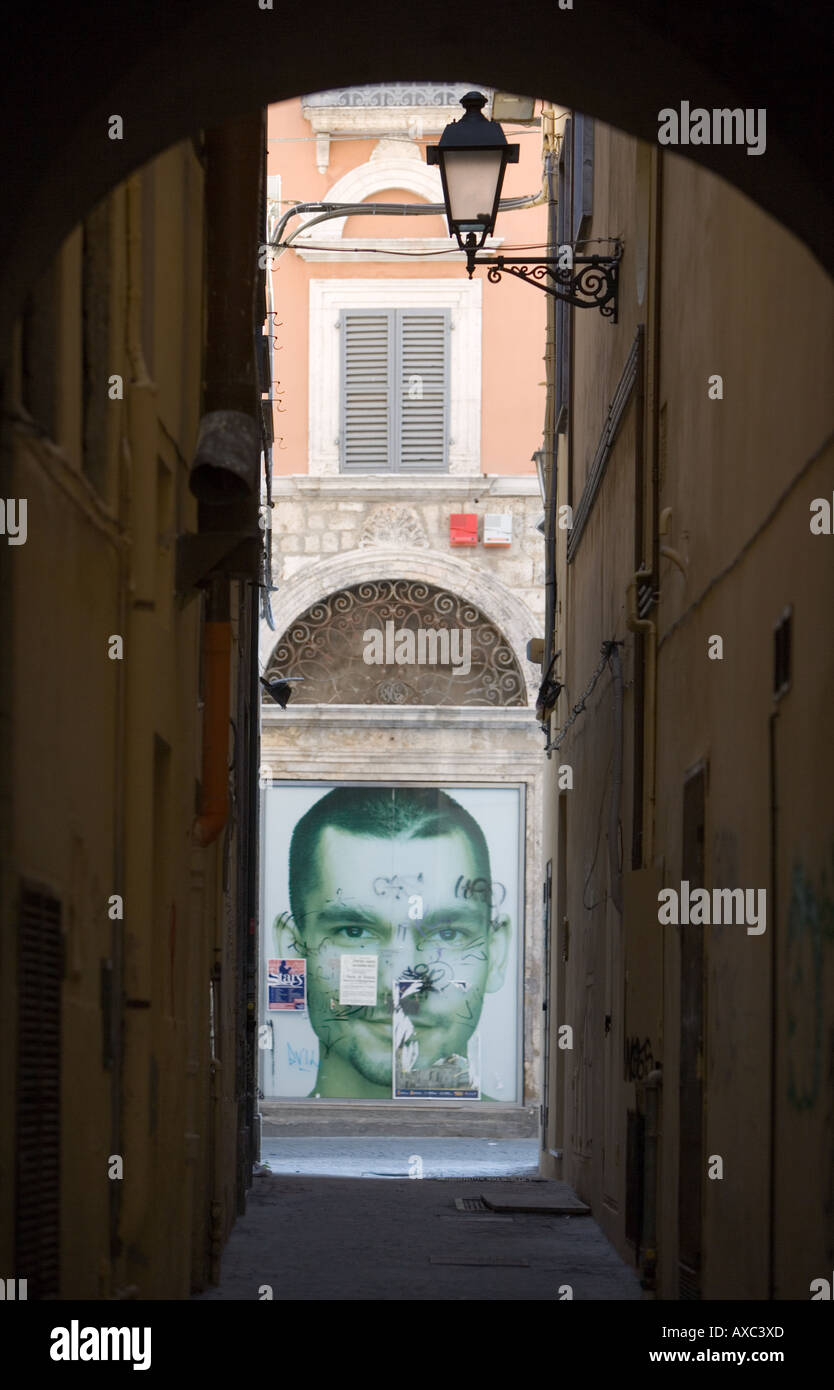 Alleyway with face and graffiti Ascoli Piceno Abruzzo Italy Stock Photo
