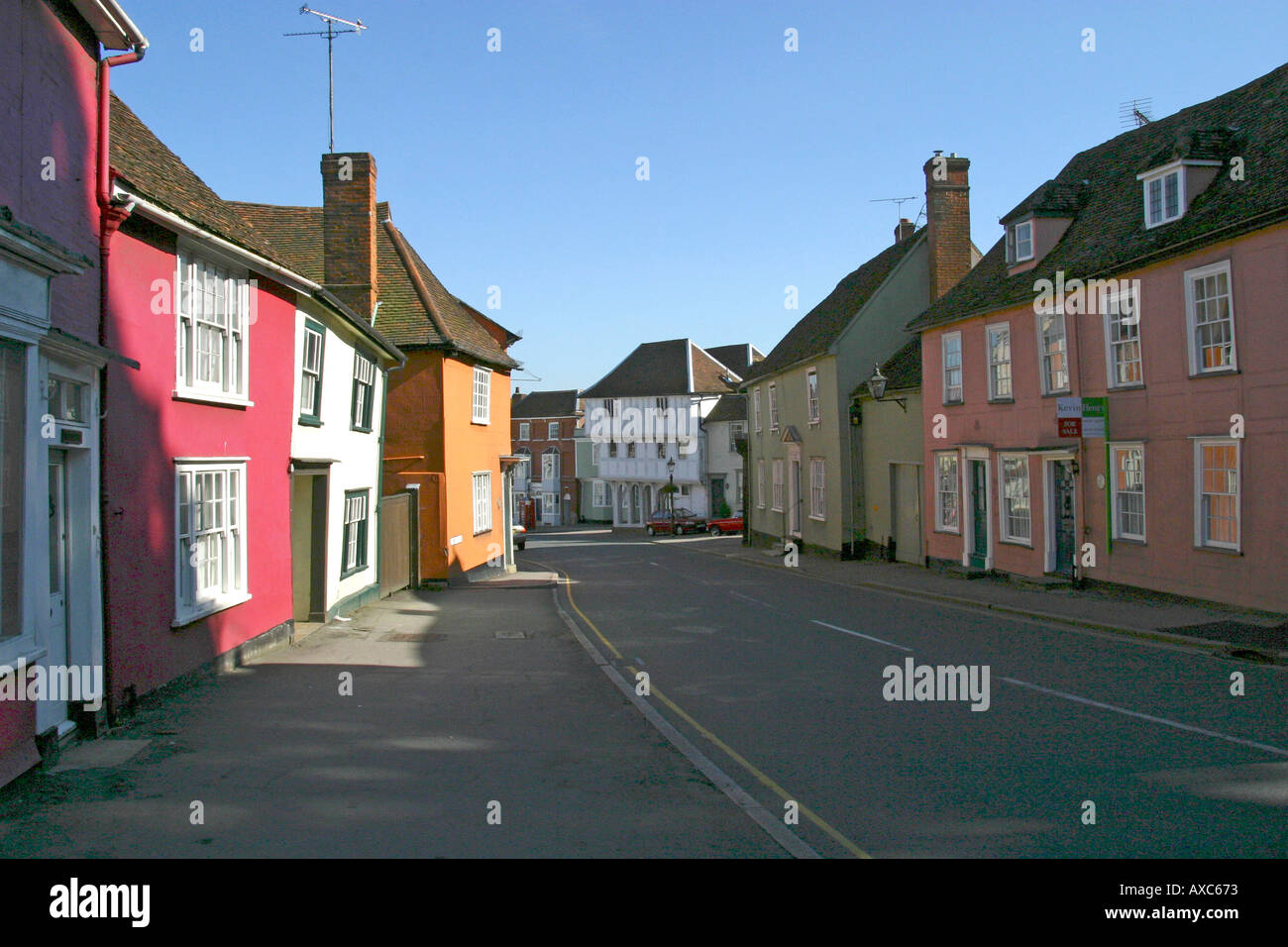 Colour washed houses in Watling Street by the church Thaxted Essex GB