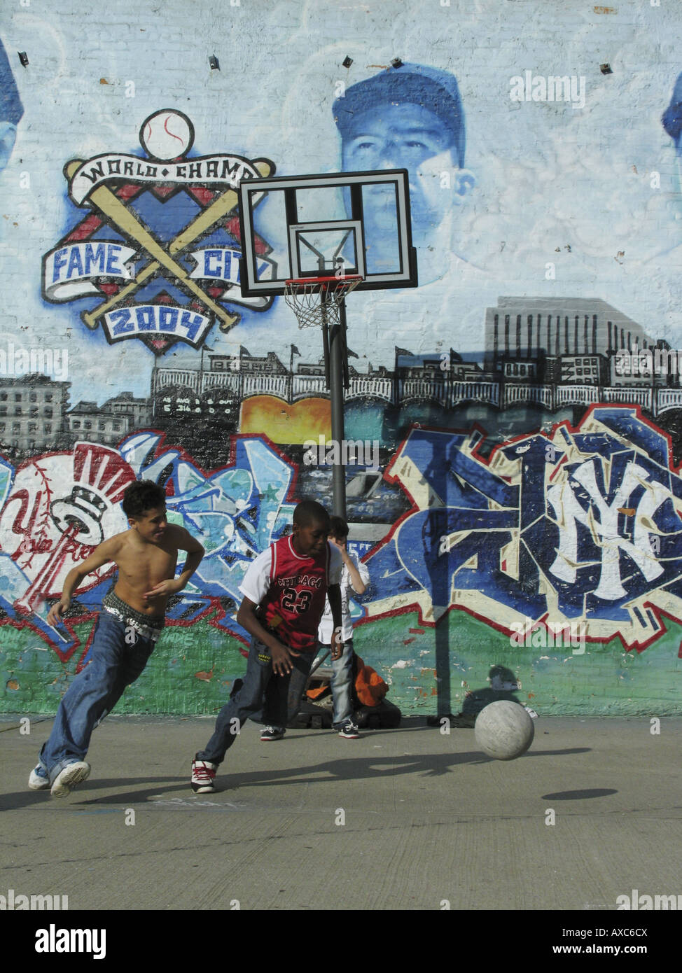 boys playing basketball on a playground near a building with