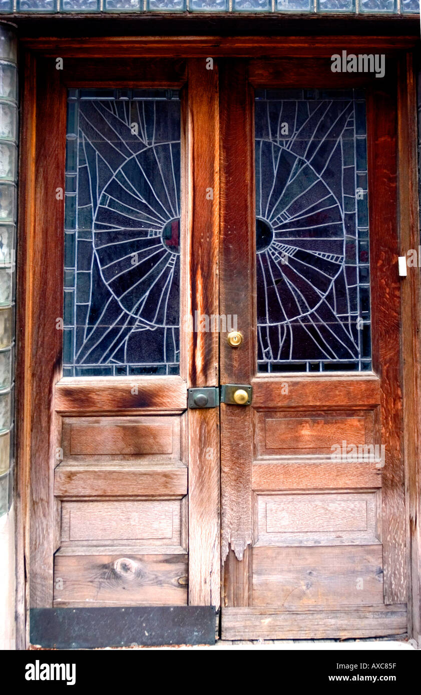Pair of antique doors on building under restoration with weather beaten