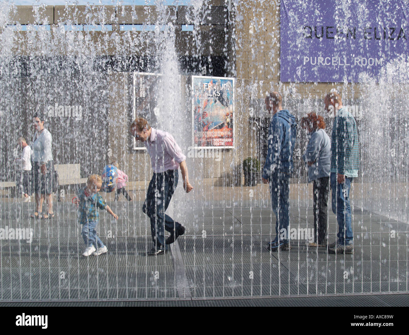 family people in waterwall water fountain squirts southbank river thames london Stock Photo
