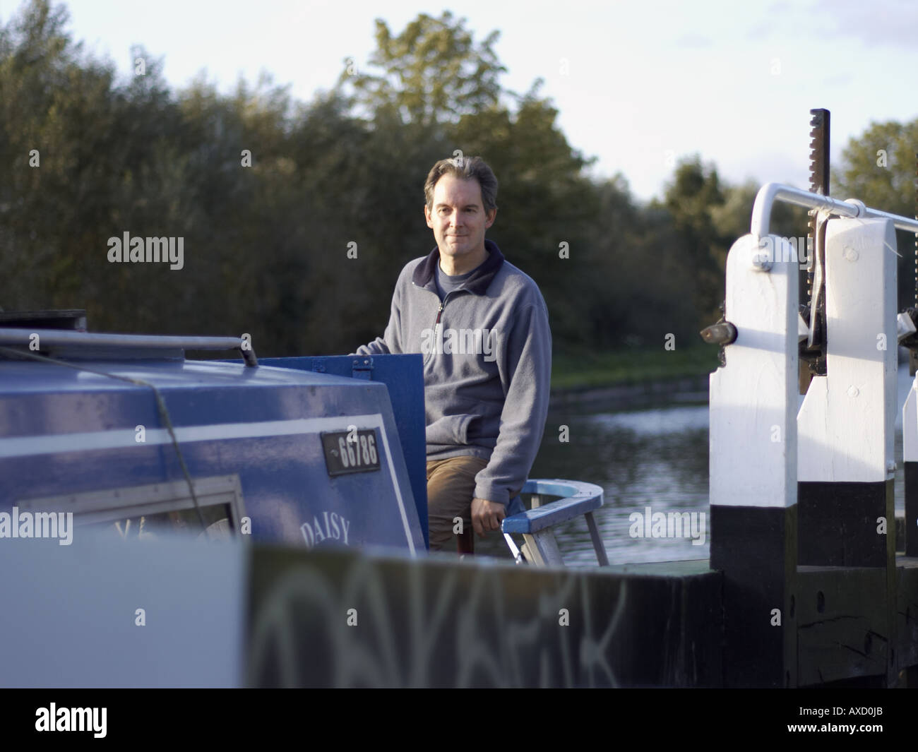 Man steering a narrowboat hi-res stock photography and images - Alamy