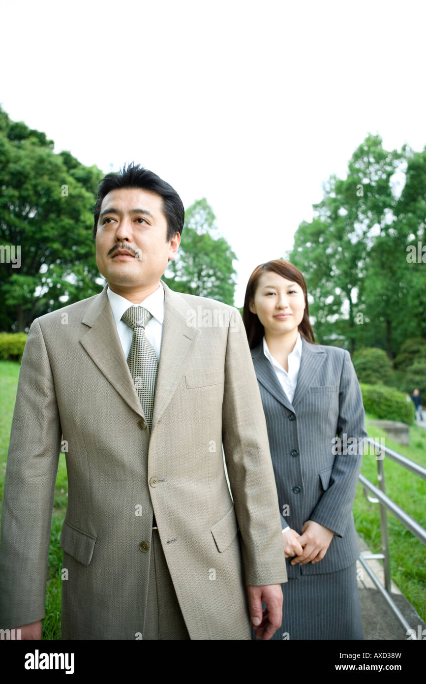 Two business people walking Stock Photo - Alamy