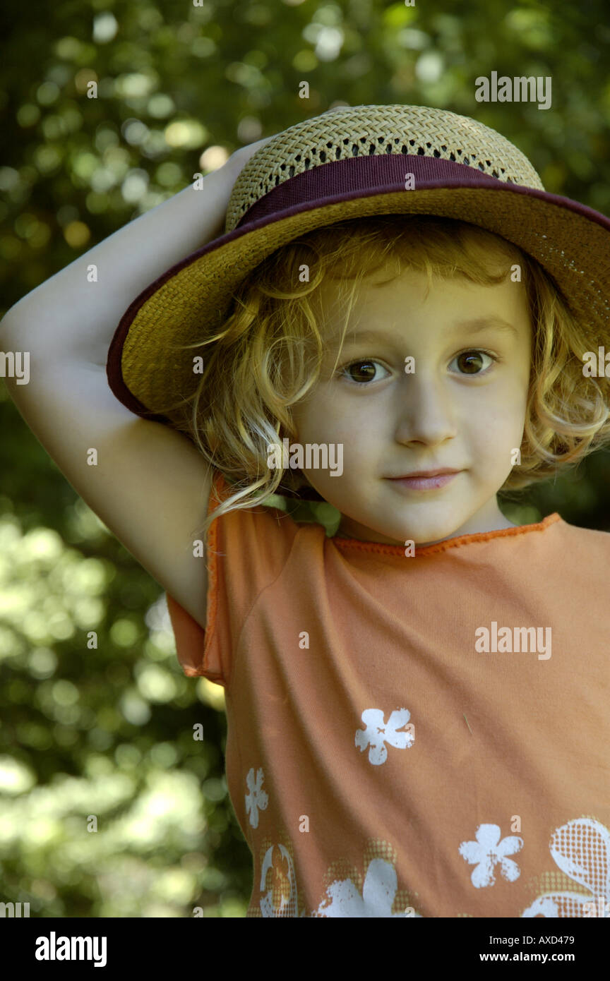 Little girl wearing a straw hat, Provence, France. Stock Photo
