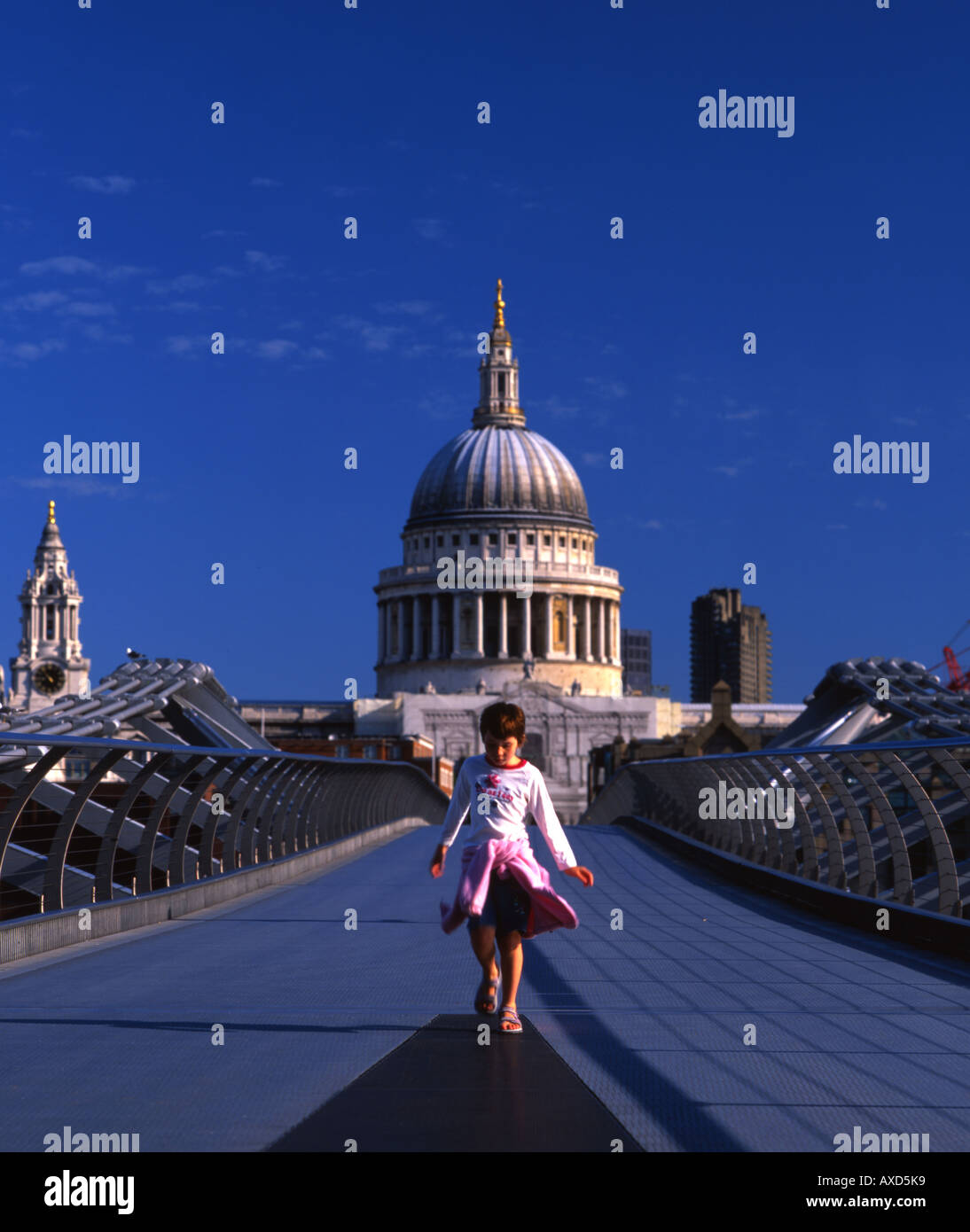 Little Girl crosses the London Millenium Bridge with St Paul's Cathedral in the background. Stock Photo