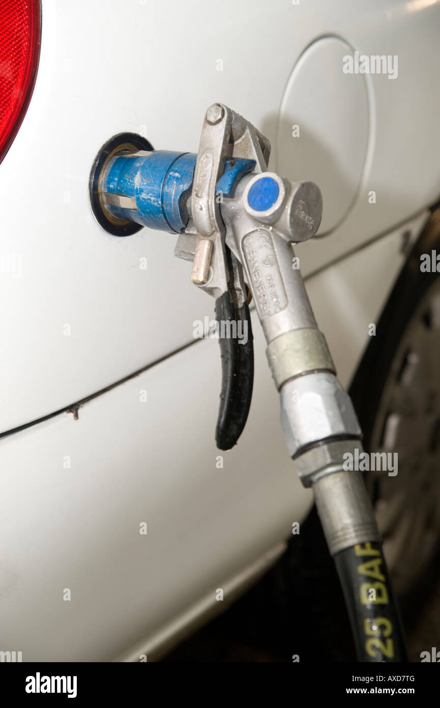 compressed natural gas vehicle with fuel filler hose at a petrol