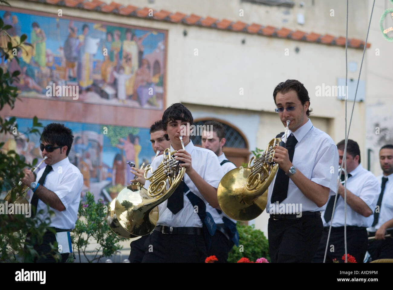 Young band members playing the french horn for the festival of Saint Andrew through the streets of Amalfi, Campani, Italy Stock Photo
