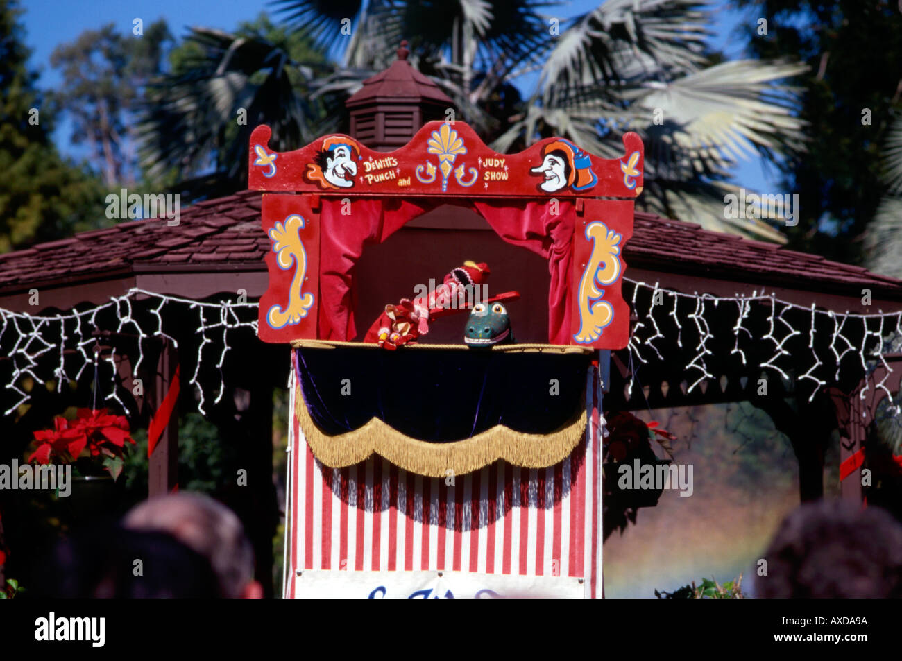 Punch hitting the crocodile over the head Punch and Judy show Stock