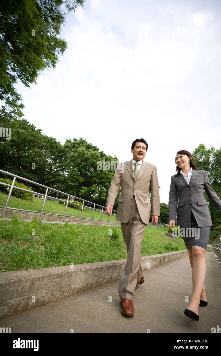 Two business people walking Stock Photo - Alamy