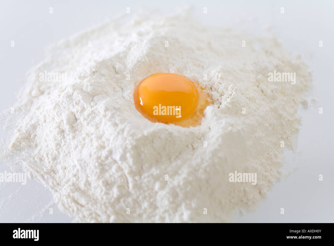 Egg yolk on flour, closeup Stock Photo Alamy
