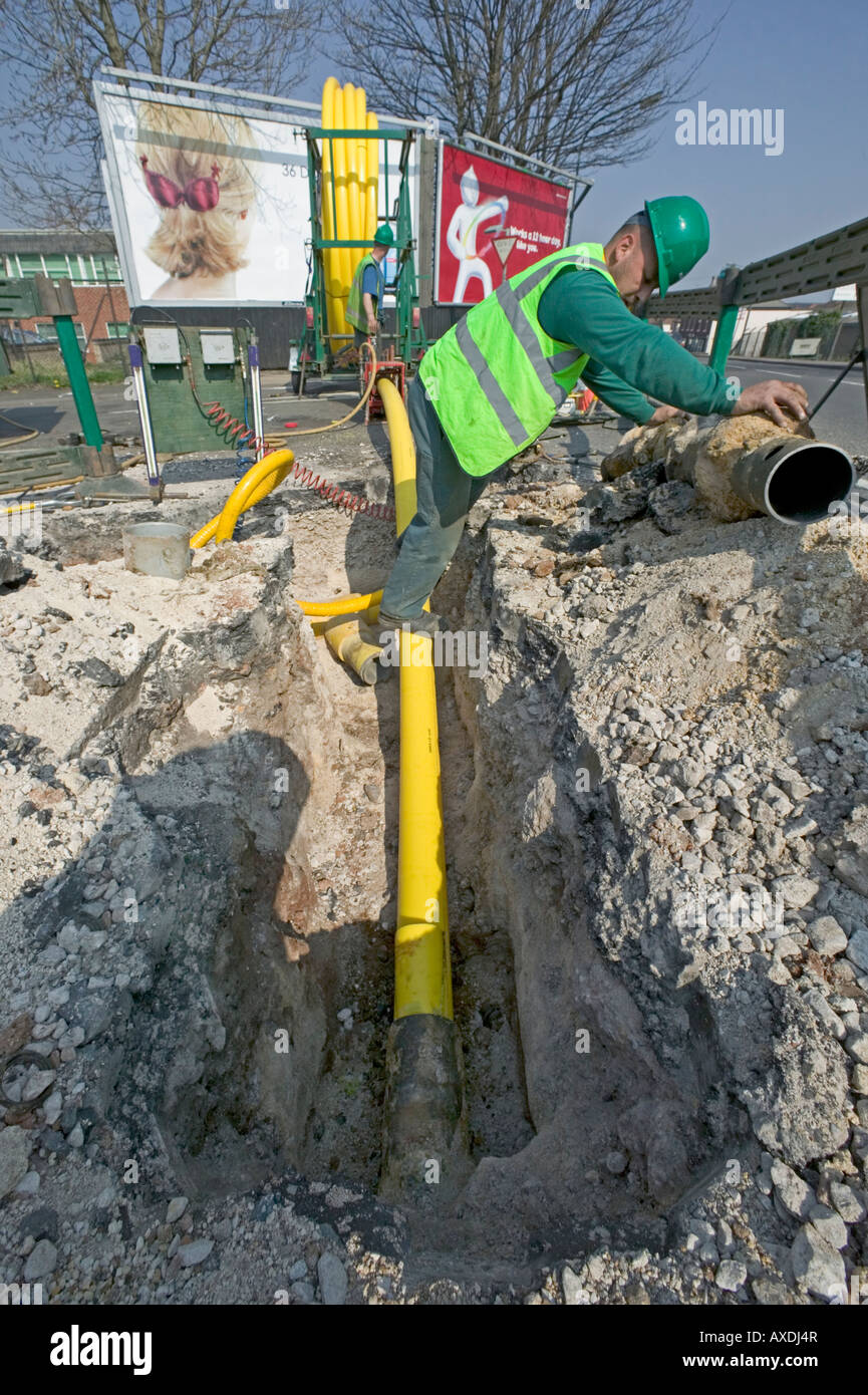Rehabilitating a city's natural gas supply by replacing deteriorating Victorian cast iron pipes with modern polyethylene tubing. Stock Photo