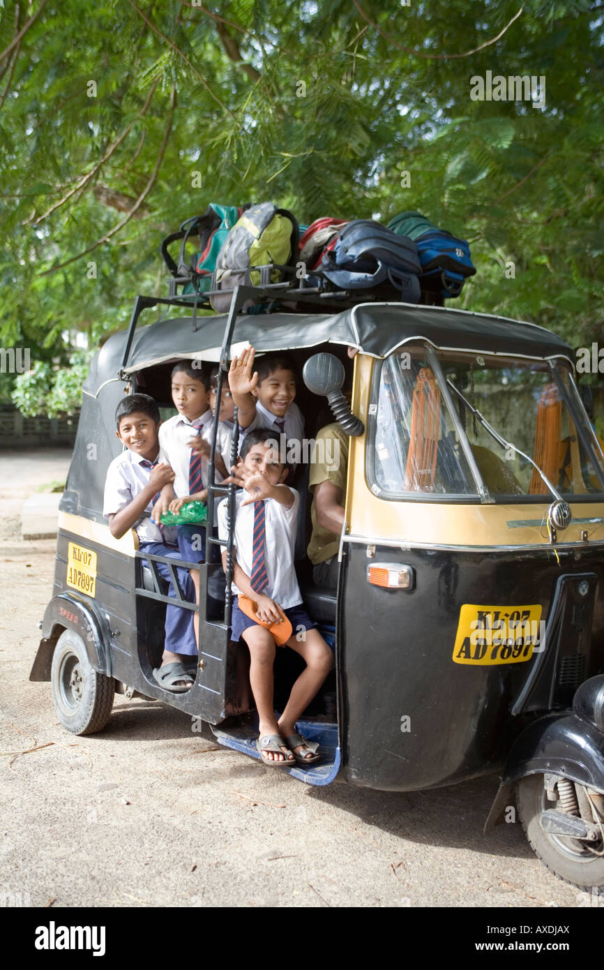 Young Indian schoolboys packed tightly into a rickshaw a popular mode of school transport Fort Kochi Cochin Kerala India Stock Photo