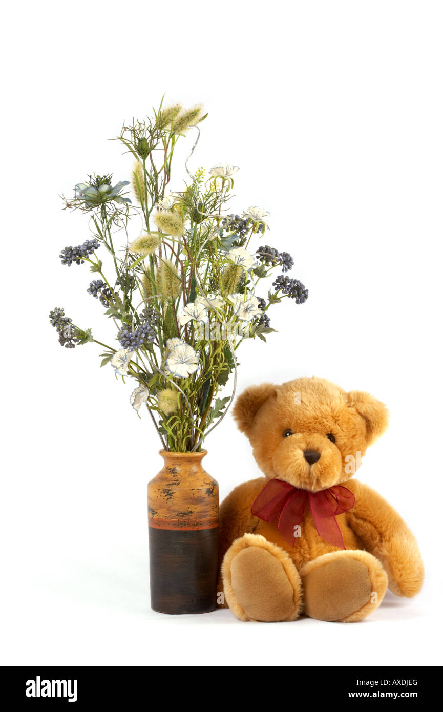 Teddy bear and vase of flowers Stock Photo
