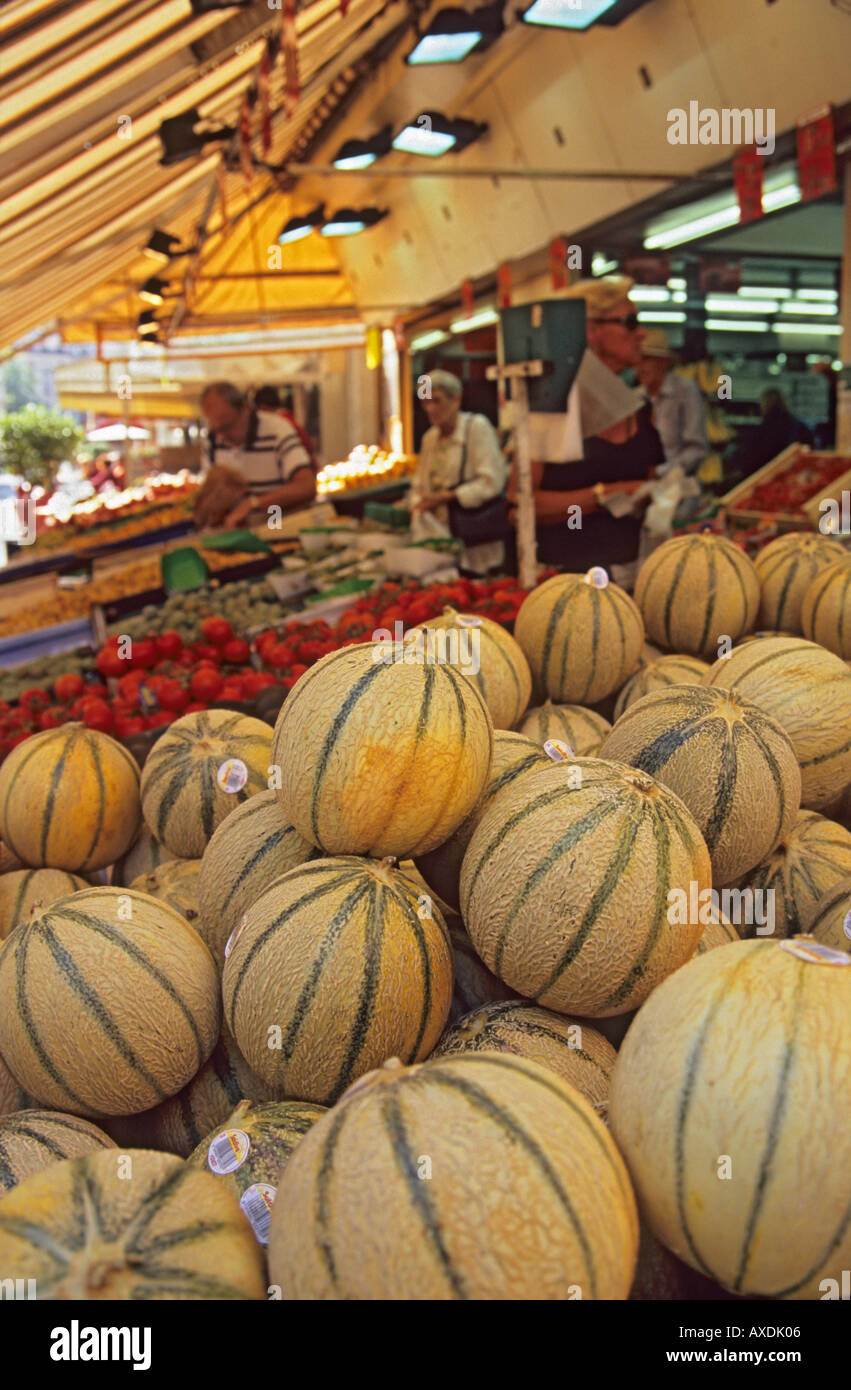 Melons on a fruit and vegetable stall in market street Rue Cler Paris