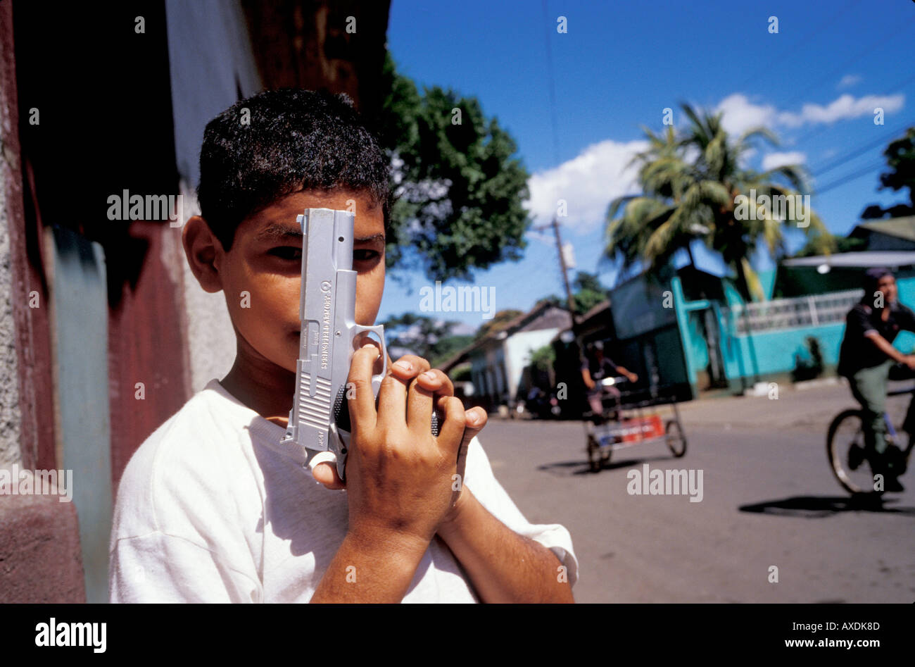 A Nicaraguan boy poses with his plastic toy pistol just like he saw on American television. Stock Photo