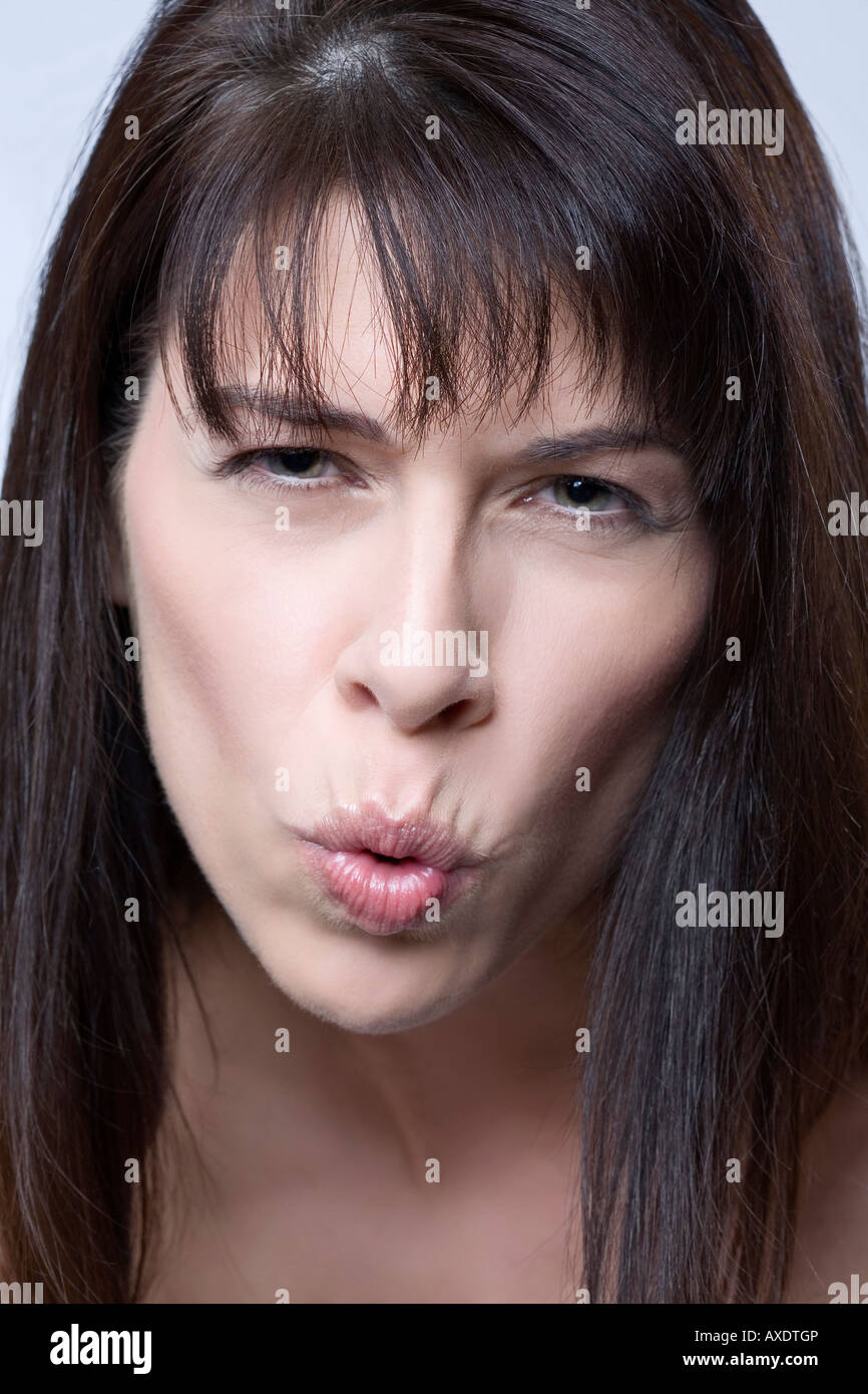 Brunette woman pulling faces, portrait Stock Photo