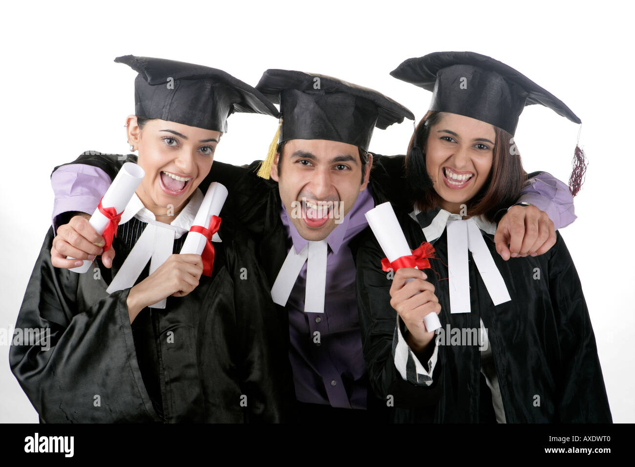 Portrait of three friends holding graduation degrees and cheering Stock ...