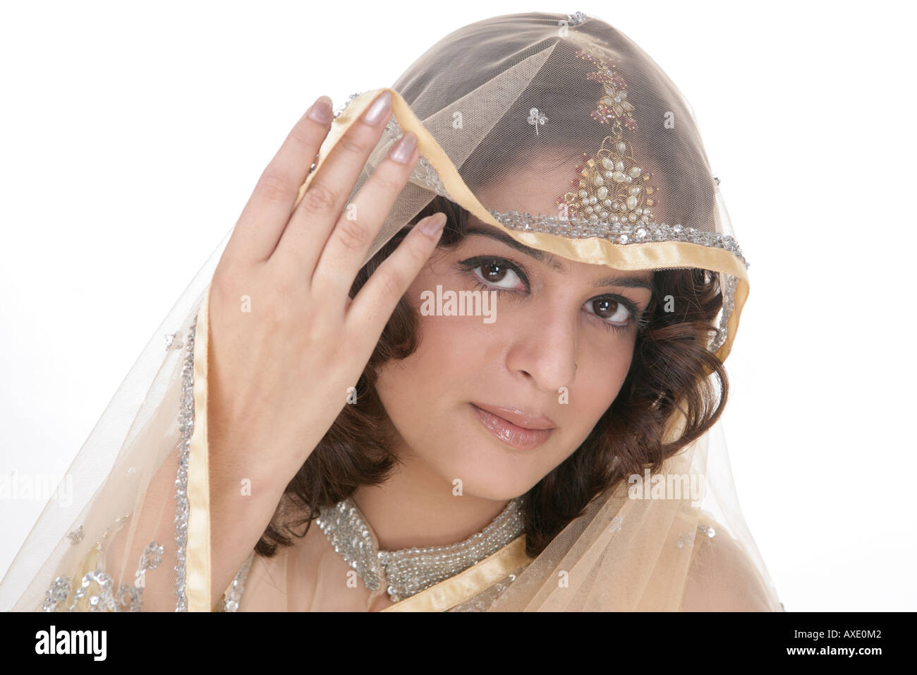 Portrait of a young woman peeking from her veil Stock Photo - Alamy