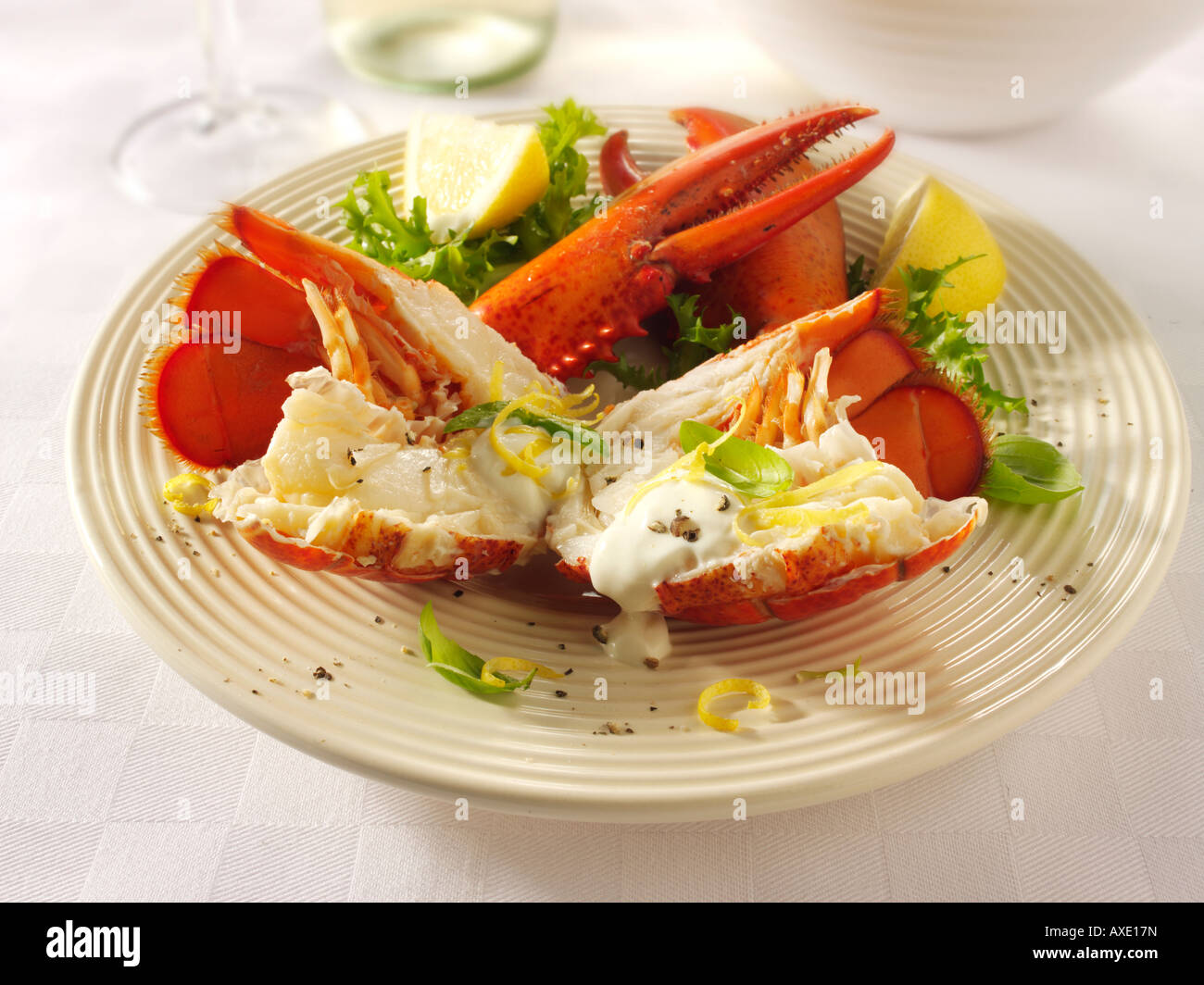 Halved fresh cooked Lobster with a lemon mayonnaise sauce Stock Photo