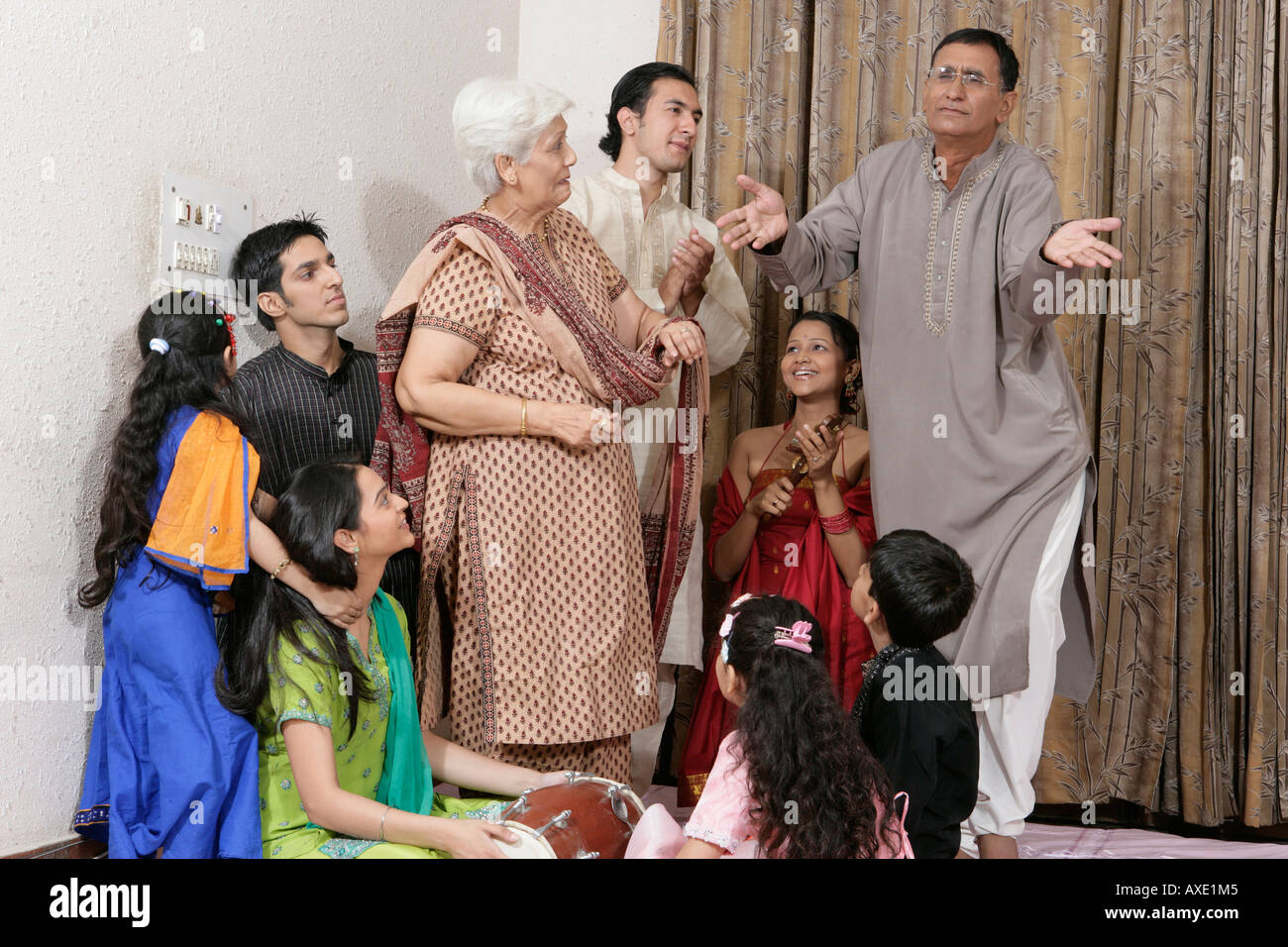 Senior man dancing with his family looking at him Stock Photo
