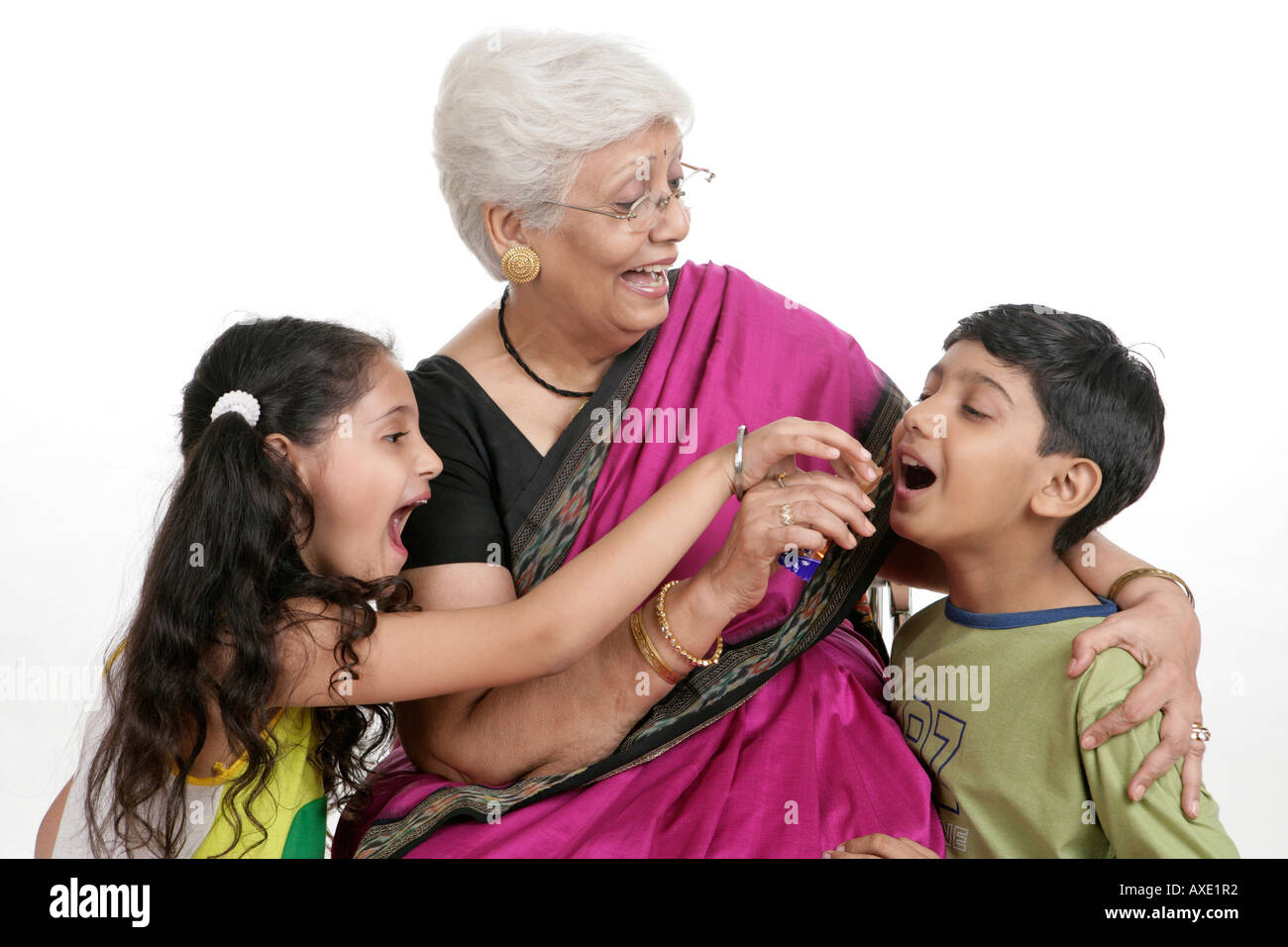Grandmother giving chocolate to her grandson Stock Photo