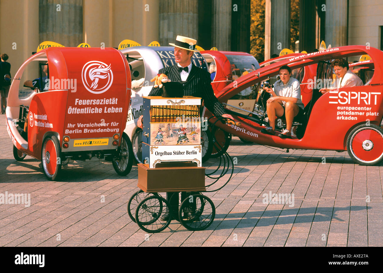 Organist with historic organ and Bike Taxis Pariser Platz Brandenburger Tor Berlin Germany Stock Photo