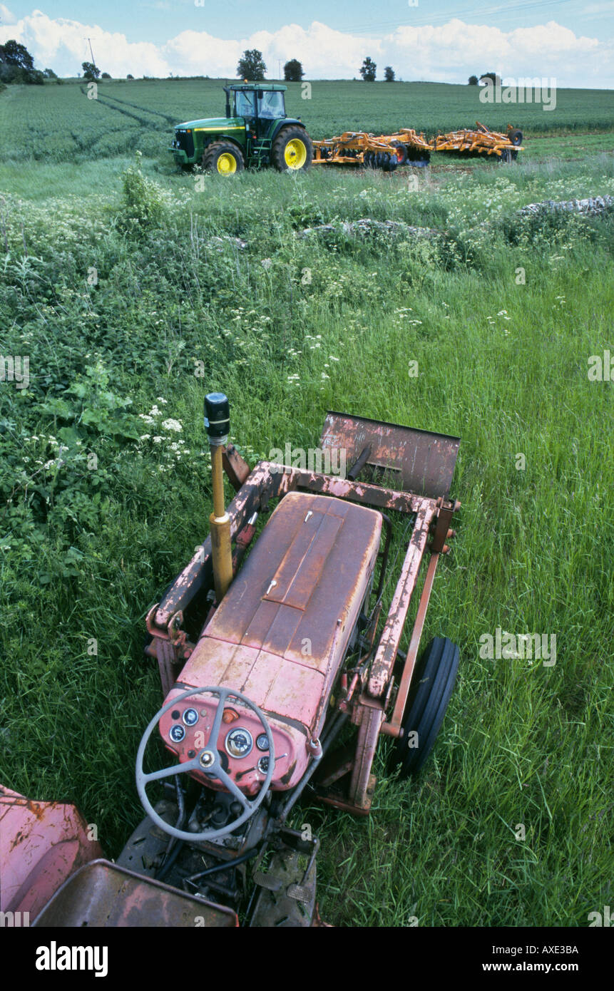 UK COTSWOLDS MORETONINMARSH MODERN NEW TRACTOR WITH PLOUGH AND OLD