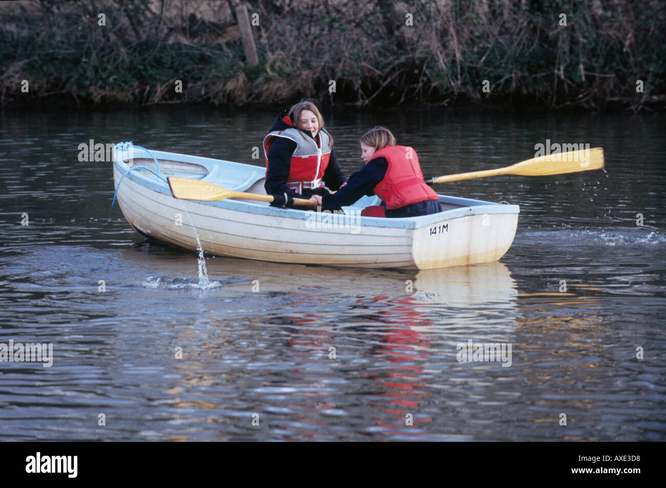 UK NORFOLK BROADS TWO GIRLS IN A ROWING BOAT WITH LIFE JACKETS WATER