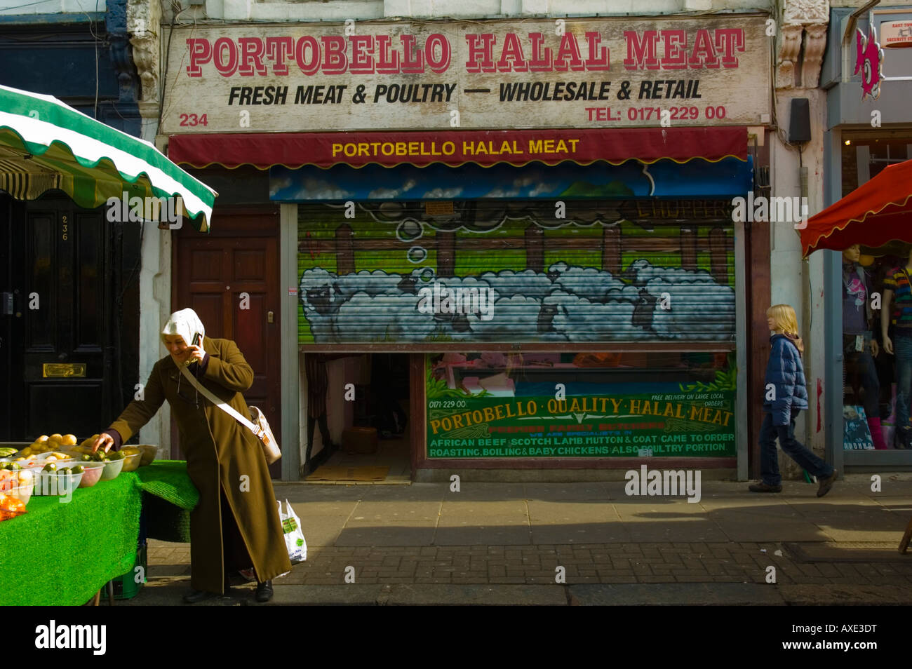 Muslim woman talking on mobile phone while shopping at Portobello Road market in London UK Stock Photo