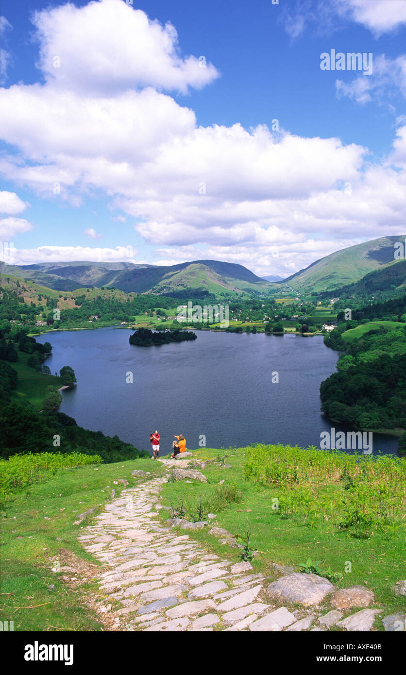 Walkers on Loughrigg Fell above Grasmere valley in the Lake District National Park. Home of poet Wordsworth. Cumbria, England. Stock Photo