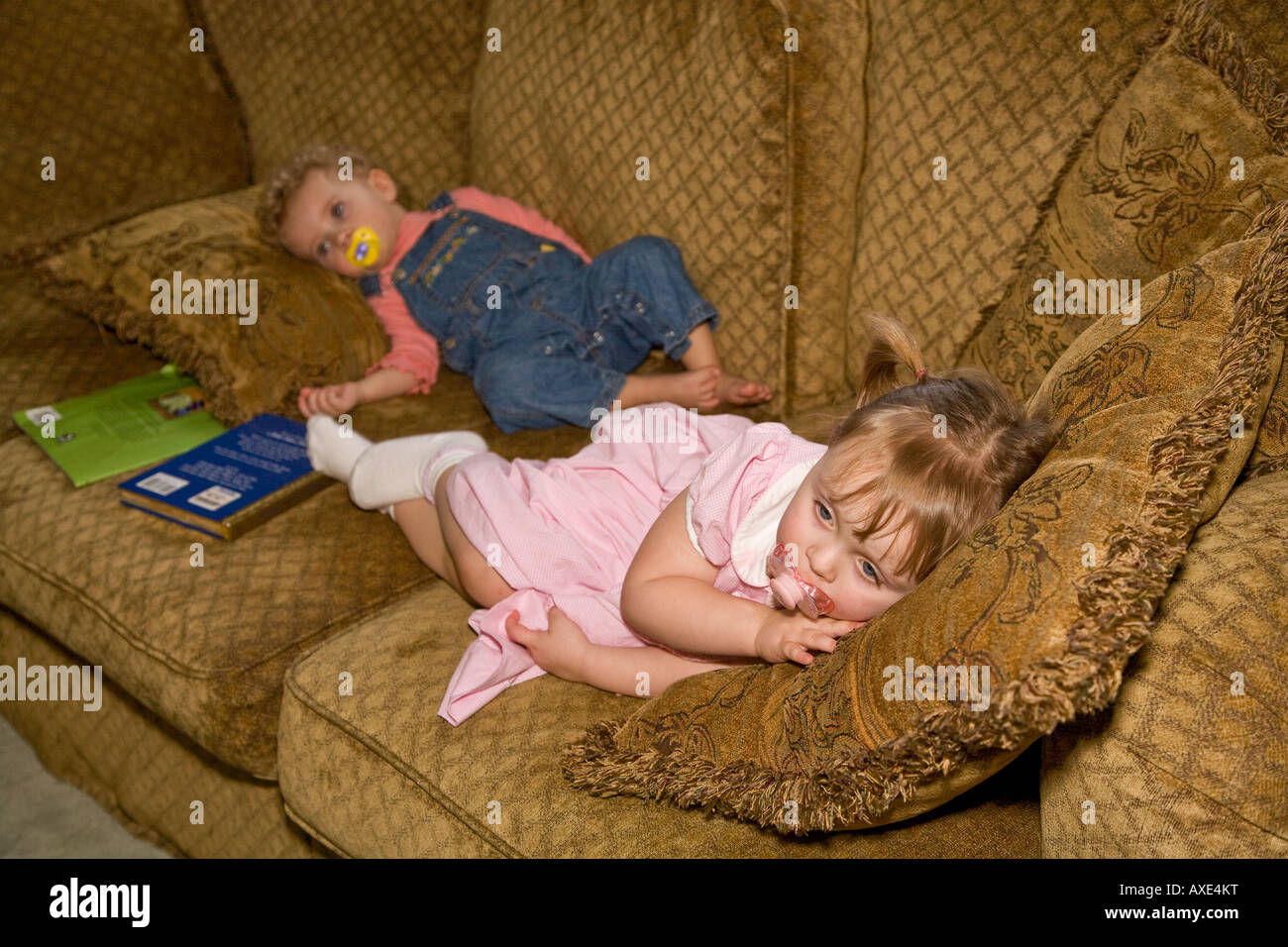 Tired toddlers on couch Stock Photo Alamy