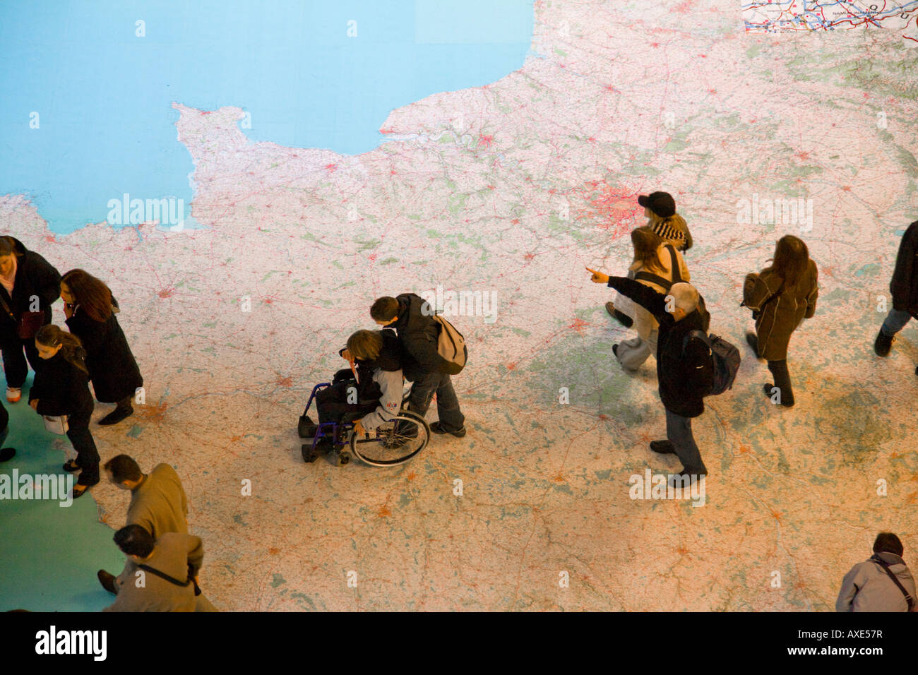 People moving across floor map of France Stock Photo