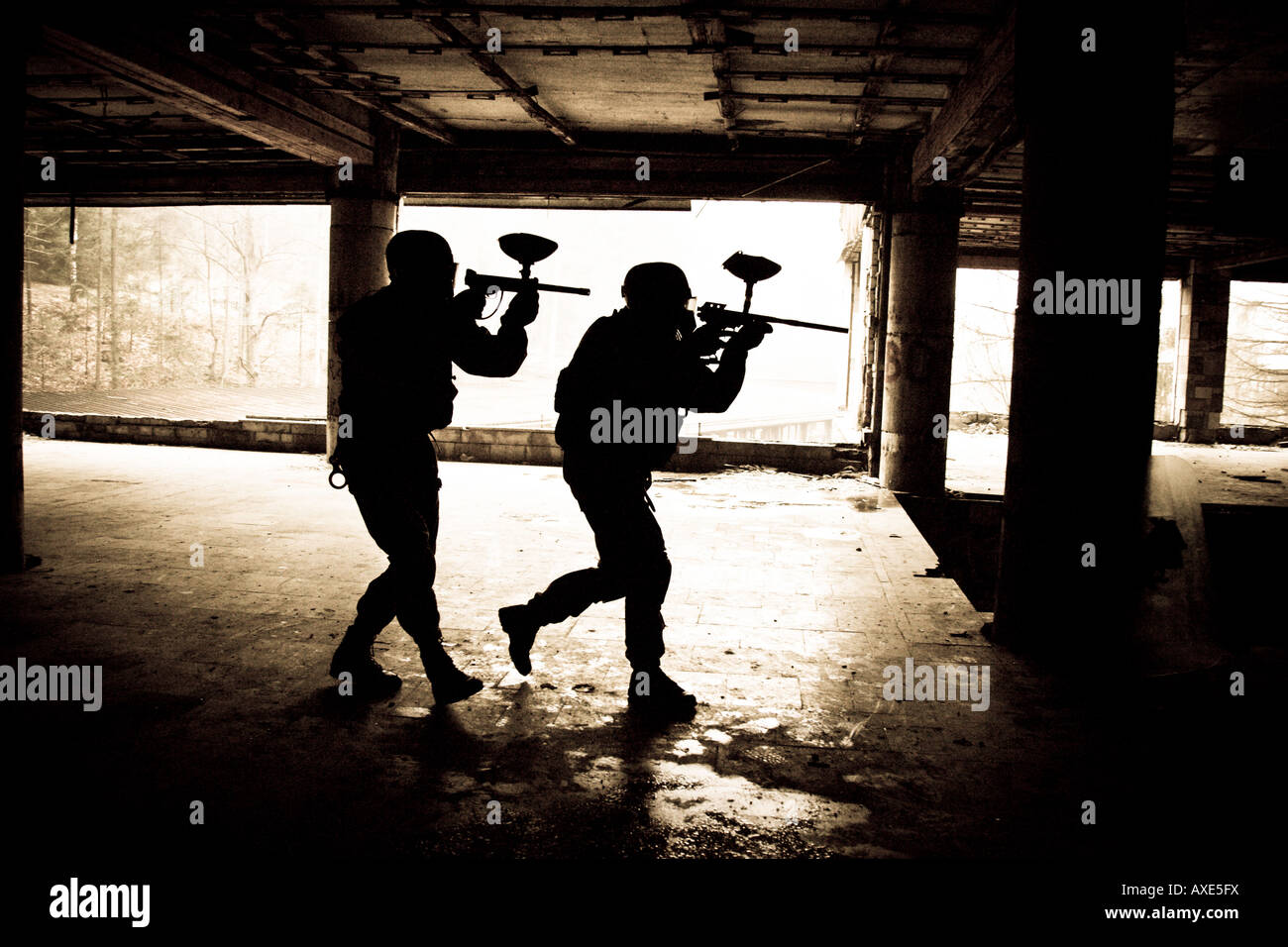 Two anti-terrorists during training action, using paintball guns. Stock Photo