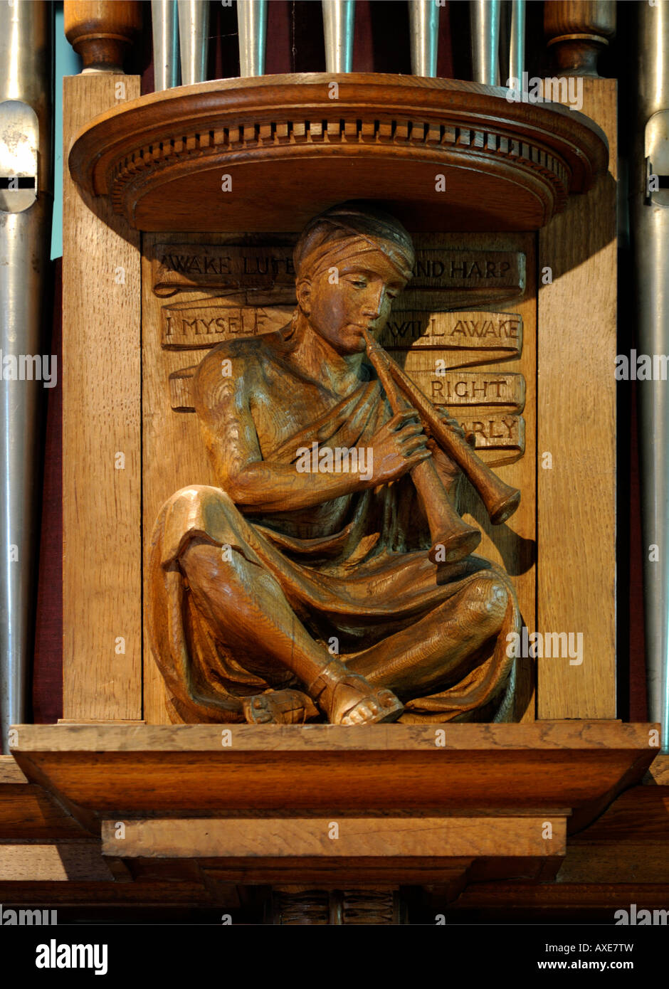 Boy playing pan-pipes. Wooden carving on organ case. Church of Saint Mary and Saint Michael, Great Urswick, Cumbria, England. Stock Photo